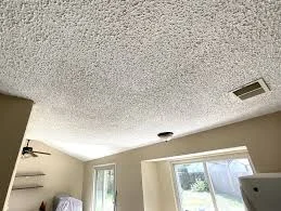 Interior popcorn ceiling texture, a common material raising the concern of what does asbestos look like in older home finishes