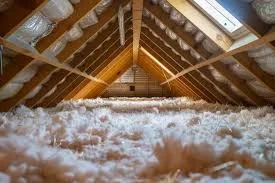 Attic space with white loose-fill insulation that may contain asbestos insulation in attic