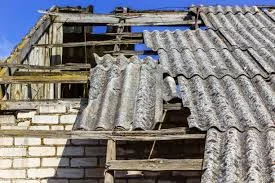 Old damaged roof structure covered with asbestos shingles