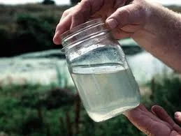 how can you tell if water is contaminated portrayed with dirty water in glass jar.