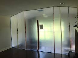 Plastic containment barrier set up for mold remediation showing if can you stay in home during mold remediation is safe